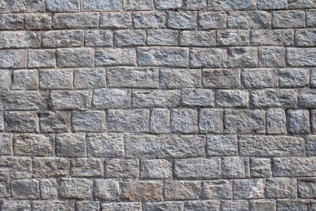 Stone brick wall texture. Modern slate outdoor decorative rocks. Tile textured of general layout of stones masonry with mixed block various shapes and sizes. Slate split mosaic pattern.の写真素材