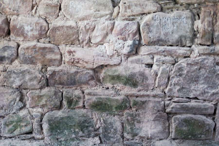 Wall texture background stone grunge facing coarse. Rough stone or rock texture of mountains. Grungy aged stonework city. Front old antique decor house.の写真素材