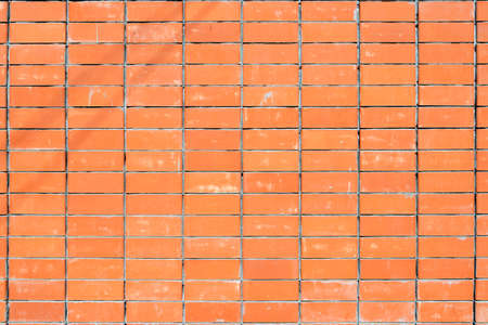 Red brick wall texture grunge background for interior and home design. Wide panoramic photo of the building with good detail. Abstract brickwork wallpaper surface of building blocks.の写真素材