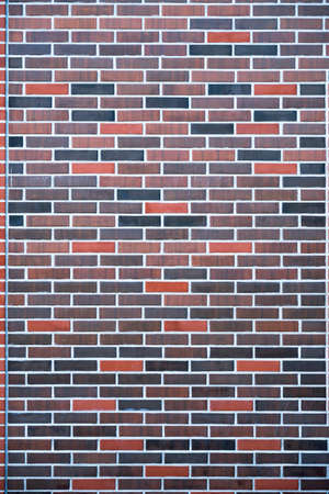 Abstract modern dark brick wall background texture. Multicolor blocks masonry horizontal architecture wallpaper.の写真素材