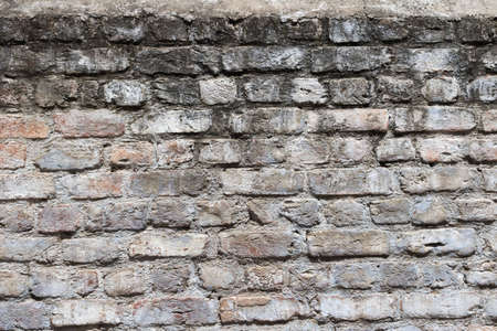 Abstract weathered texture of old grunge aged brick wall background, grungy rusty blocks of masonry horizontal architecture wallpaper. Surface brickwork blocks home and interior.の写真素材