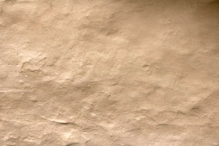 Wall grunge texture abstract background. The wall surface is plaster or natural primer material. Grungy vintage natural clay textured surface material.の写真素材