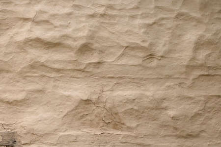 Wall grunge texture abstract background. The wall surface is plaster or natural primer material. Grungy vintage natural clay textured surface material.の写真素材