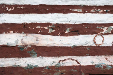 Painted wooden bands and dry-stacked rubble stone masonry. Abstract background texture mixed for old stone walls. Tibetan village house. Traditional building technology Himalaya, Nepal.の写真素材