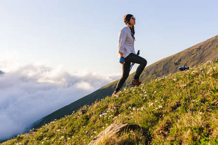 Woman adventurer skyrunning in mountains with Travel hiking lifestyle concept active weekend summer vacations athletic personの写真素材