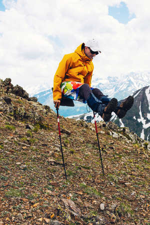 Man Traveler on mountain summit enjoying having fun doing gymnastics Travel Lifestyle success concept adventure active vacations outdoor happiness freedom emotionsの写真素材