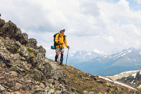 Man backpacker hiking on high mountains alone outdoor active lifestyle travel adventure vacations
