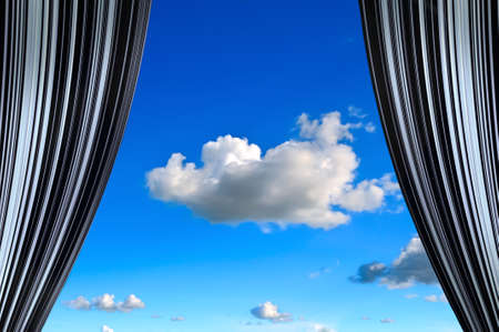 Window curtains with view of clouds and sky in the middleの写真素材