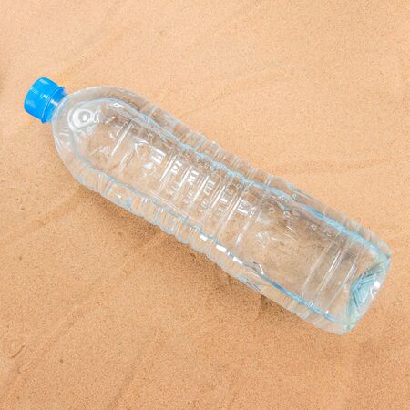 Plastic water bottle on the sand 