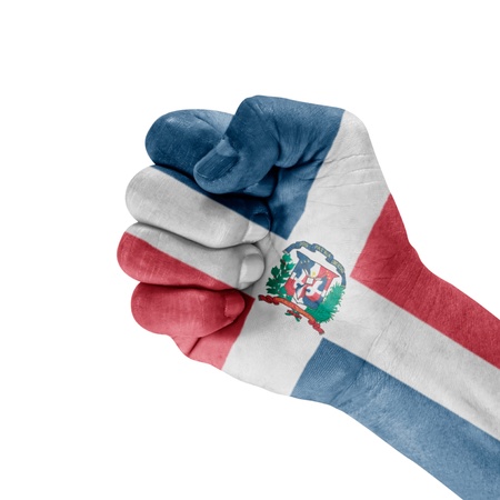 Dominican Republic flag on hand with clenched fist gesture over white background.の写真素材