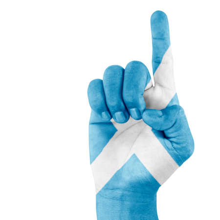 Scotland flag drawn on pointing up hand gesture with white background.の写真素材