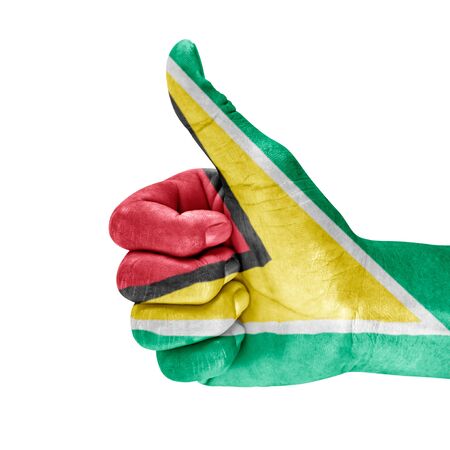 Guyana flag on thumb up hand with a white background.の写真素材