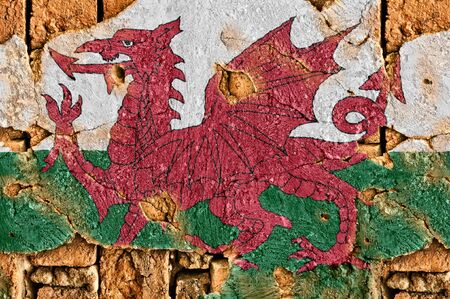 Grunge flag of Wales on old wall background.の写真素材