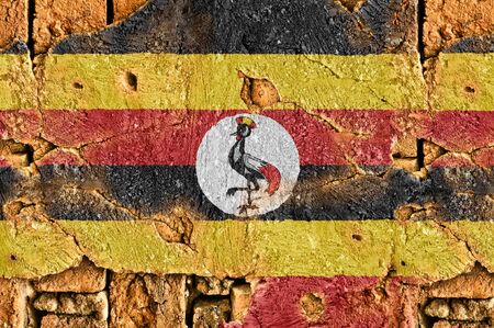 Grunge flag of Uganda on old wall background.の写真素材