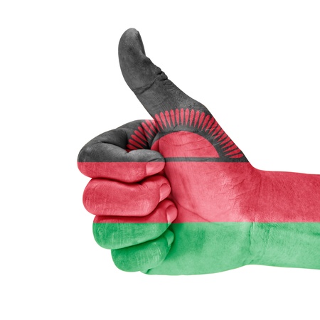 Malawi flag on thumb up hand with a white background.の写真素材