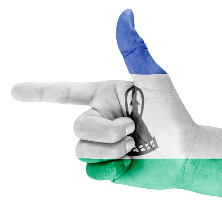 Lesotho flag drawn on shooting hand gesture with white background の写真素材