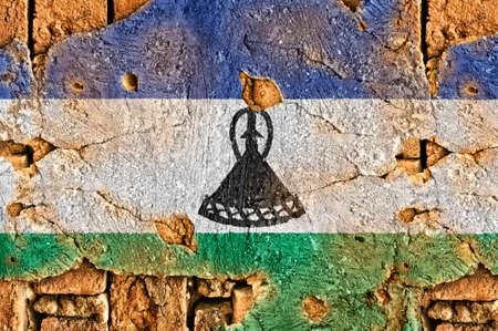 Grunge flag of Lesotho on old wall background の写真素材