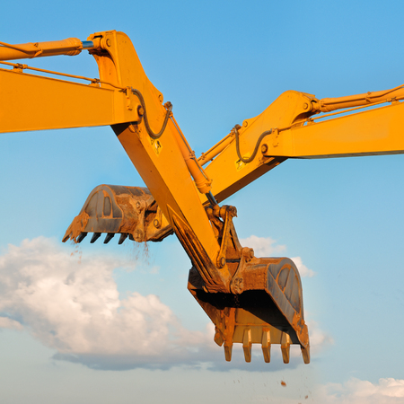 Excavator loader machine on blue sky background  