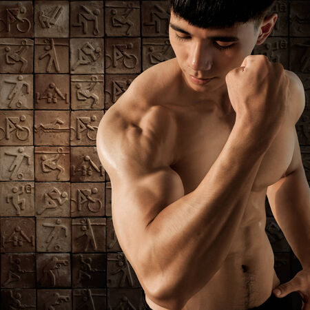 Muscular male on ceramic mosaic background の写真素材