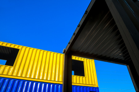 Cargo containers blue and yellow on blue sky background.の写真素材