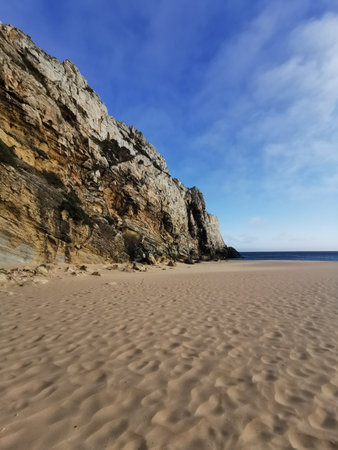 beach with stony coast line in portugalの写真素材