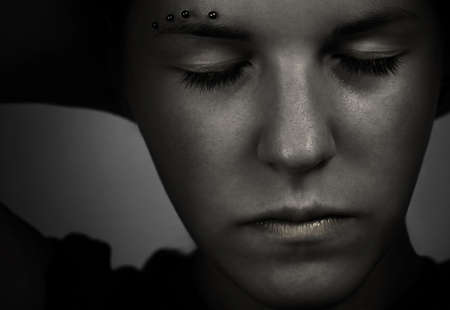 Thinkful girl with the hands on the back of her head.