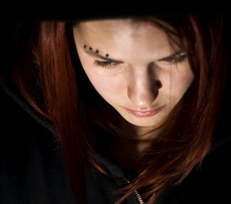 Sad redhead girl looking downの写真素材