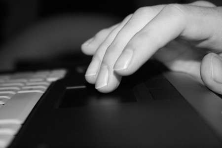 Hand on notebook touchpad