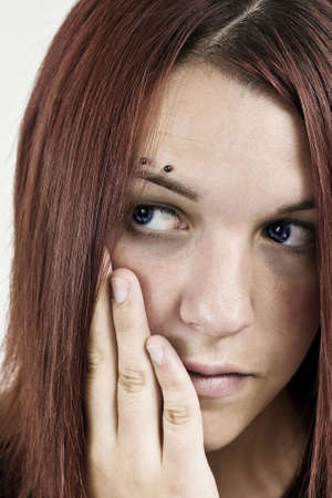 Shot of a pensive girl holding her head with hand.の写真素材