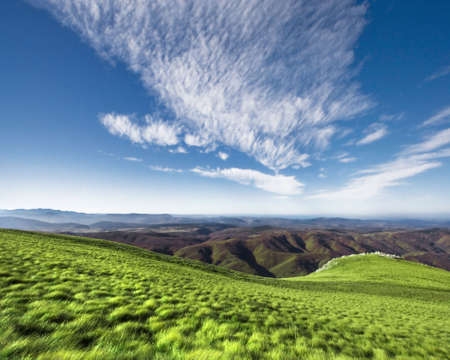 Paysage shot of a horizon on Nanos, Slovenija. Vivid blue sky with clouds and an S-shaped hill.の写真素材