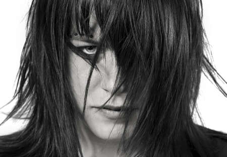 Cute girl looking aggressively at the camera, seductive.Studio shot.