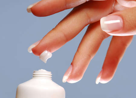 Moisturizer on the end of woman finger.の写真素材