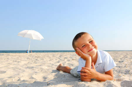 Little boy enjoying on beachの写真素材