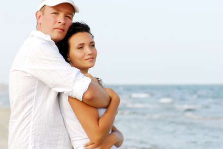 Portrait of happy couple embracing by sea.の写真素材