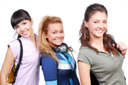 Team of three funny  girlfriends standing. Studio shot no the white background.の写真素材