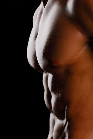 Part of beautiful male torso. Isolated on back. Side viewの写真素材