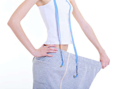 slender woman with measuring tape - isolatedの写真素材