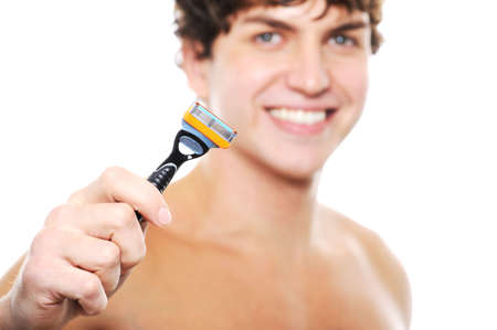 Happy laughing clean-shaven face of young man with razor in the hand  on foregroundの写真素材