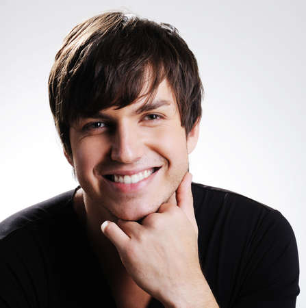 Portrait of a  pretty caucasian young guy with bright toothy smile