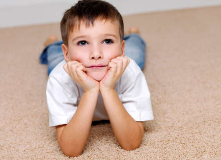 Portrait Beautiful the boy of preschool age lying on a floor and dreaming of something
の写真素材