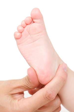 Mother making massage of child's foot isolated on white の写真素材