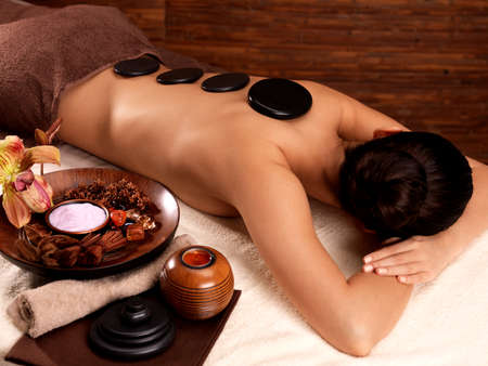 Young woman having stone massage in spa salon. Healthy lifestyle.の写真素材