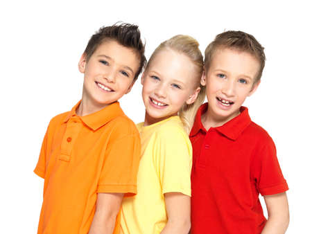Portrait of the happy children isolated on white.  Schoolchild friends standing together and looking...