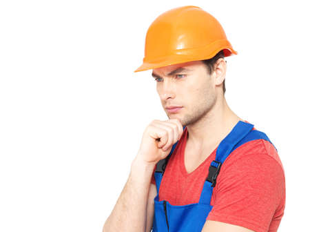 Closeup portrait of thinking handyman in uniform isolated on  white background