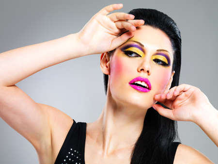 Beauty  woman with fashion makeup on  face poses at studioの写真素材