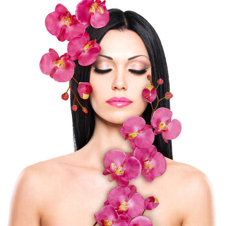 Young woman with beautiful face and fresh flowers. Skin care concept.の写真素材