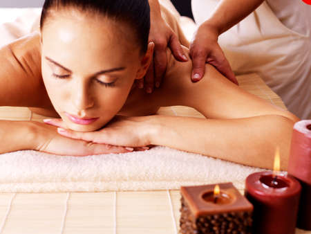 Masseur doing massage on woman body in the spa salon. Beauty treatment concept.の写真素材