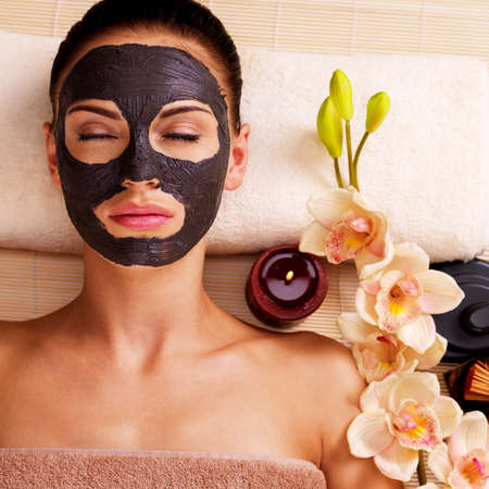 Adult woman relaxing in spa salon. Female face with cosmetic mask. Beauty treatmentの写真素材