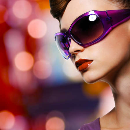 Portrait of beautiful stylish woman in fashion violet sunglassesの写真素材