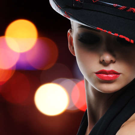 Portrait of the beautiful sexy woman with red lips in modern black hat